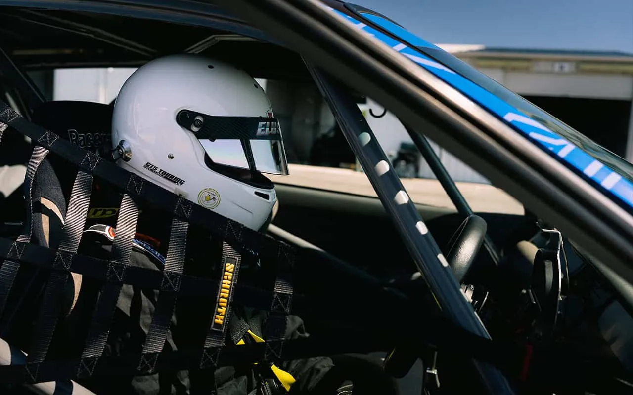A driver strapped into the Elusive Racing Civic at the track