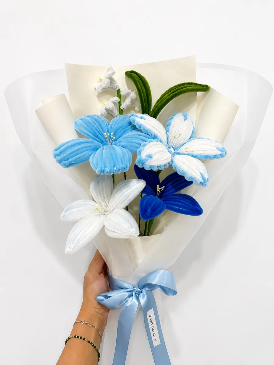 The Soft Blue bouquet held in hand